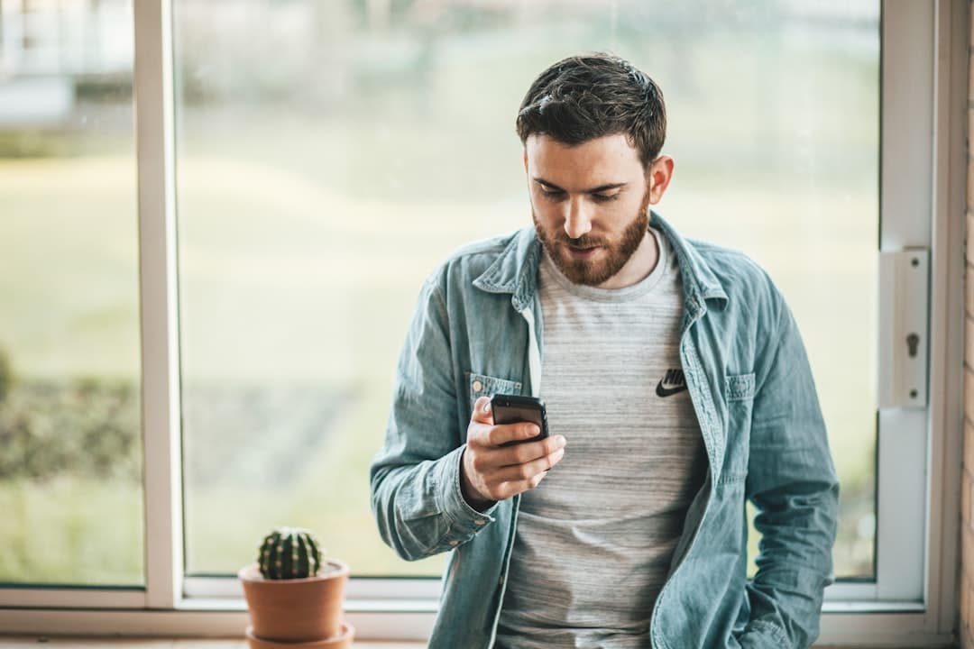 A small business owner pausing to look at their phone before posting